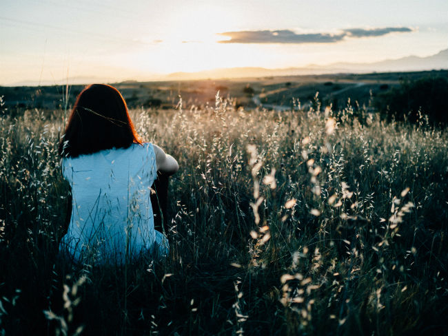 Woman Sitting in Field